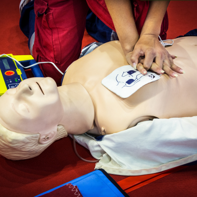 Individual practicing CPR on a manikin 
