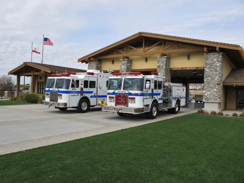 firetrucks parked in front of fire station