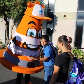 Caltrans Cone Kid hugging a student