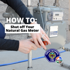 firefighter demonstrating how to shut off natural gas meter